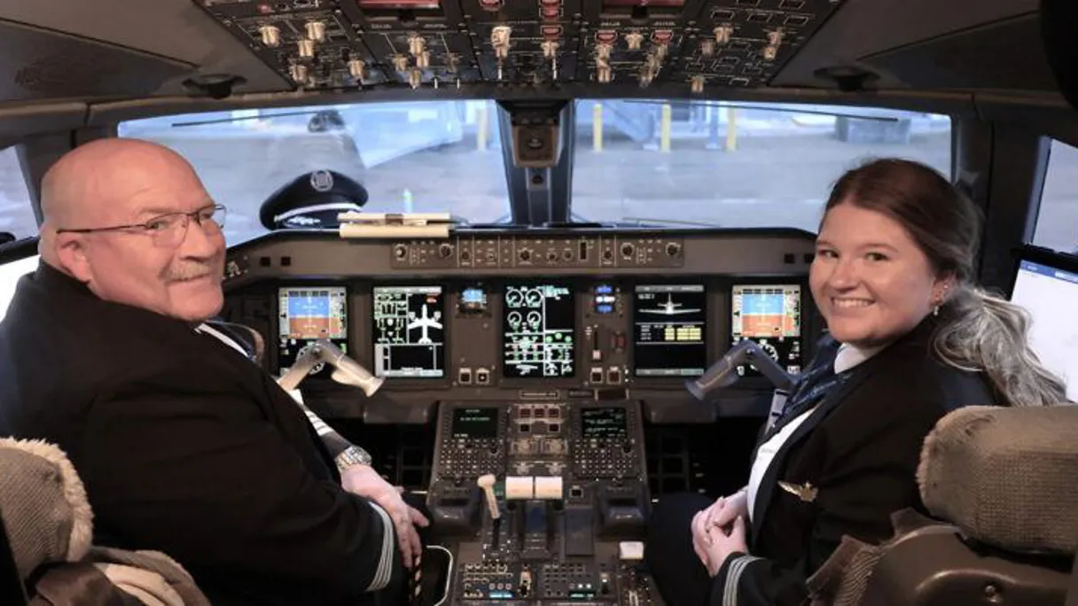 two people in the cockpit of an airplane