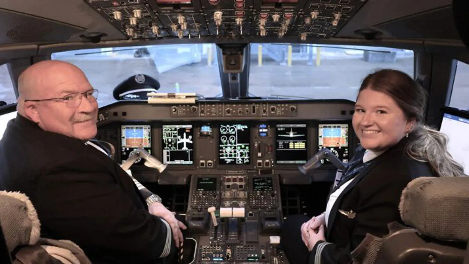 two people in the cockpit of an airplane
