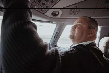 a person looking out of a cockpit of an airplane