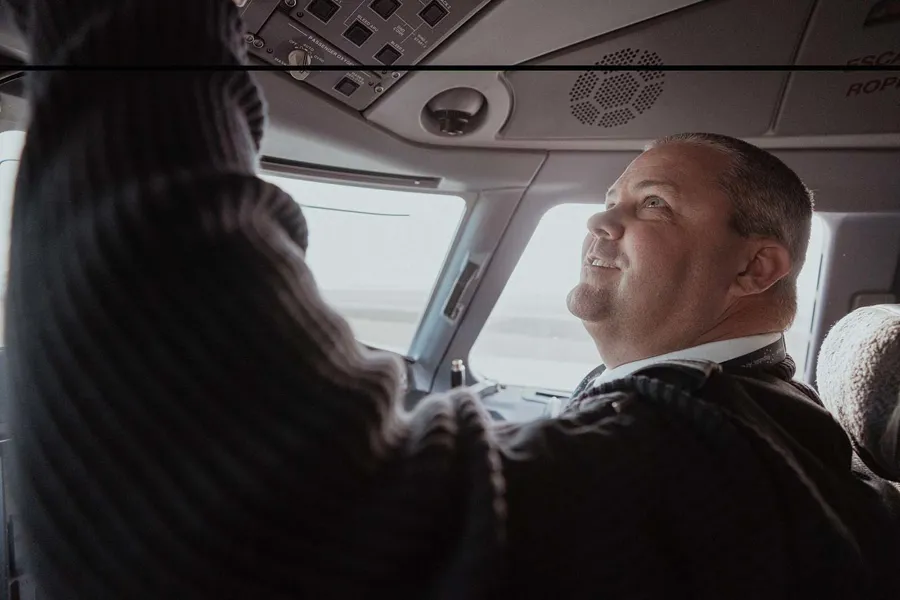 a person looking out of a cockpit of an airplane