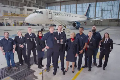 a group of people standing in a hangar