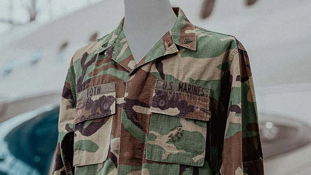 a camouflage jacket with patches on it