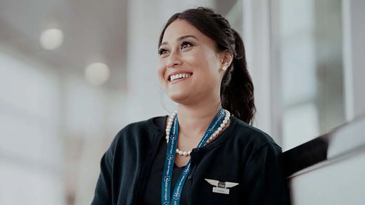 a person smiling with a necklace