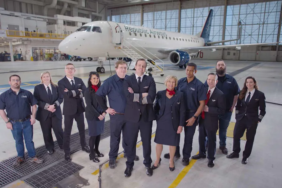 a group of people standing in a hangar