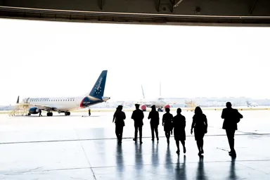 a group of people walking in an airport