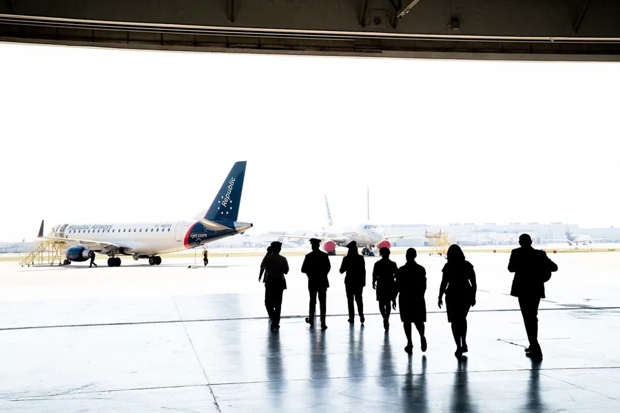 a group of people walking in an airport